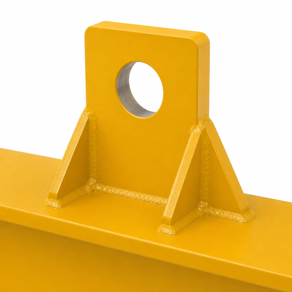 Close-up of the welded top lifting lug and gusset ribs on a steel lifting beam